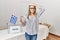 Asian young woman at political campaign election holding greece flag stressed and frustrated with hand on head, surprised and