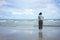 Asian young woman standing facing the sea. Feeling really lonely, heartbroken sea like a nursery of clearing the mind. The concept