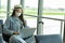 Asian young woman traveller wearing face maks using laptop computer at airport Due Covid-19 flu virus pandemic