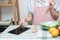 Asian young woman use finger slide on tablet screen prepare ingredients for cooking follow cooking online video clip on website in