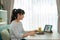 Asian young woman virtual happy hour meeting and eating food online together with her mother in video conference with digital