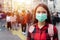 Asian Young woman walking in the city wearing protection mask on face because of air pollution, particulates and for protection