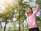 Asian young woman warm up the body stretching before morning exercise and yoga in the park under warm light morning.