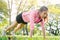 Asian young woman warm up her body by push up to build up her strength before morning jogging exercise and yoga.