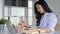 Asian young woman working in office she looked at the documents in hand with laptop and office supplies on the desk