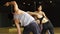 Asian young yoga female instructor assisting a male beginner balancing flexibility pose in class at gym studio. Yoga and