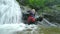 Asiatic Men Tourist Waterfall Rappelling