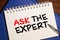 Ask an expert text is signed by marker on white paper