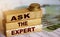 Ask the Expert words on wooden blocks. Consulting a professional, master or consultant for a solution and advice business concept