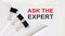 ASK THE EXPERT written on a white page with office tools