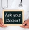 Ask your Doctor - Physician holding chalkboard with text