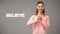 ASL teacher gesturing believe, text on background, communication for deaf, help