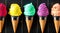 Asorted of ice cream scoops with cones in row on black background. Colorful set of ice cream scoops of different flavours. Sweet