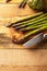 Asparagus. and an artichoke on a cutting board with a knife, sliced. on a wooden background. Culinary background. Diet. Delicious