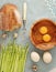 Asparagus, bread and quail eggs and chicken eggs broken