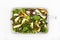 Asparagus, courgette and hazelnut salad in a rectangular dish wi