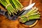 Asparagus. Fresh raw organic green Asparagus sprouts closeup. On wooden table background. Healthy vegetarian food