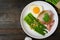 Asparagus in oyster sauce with fried rice,bacon and egg in white dish on wooden table background