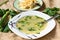 Asparagus soup, herbs and boiled asparagus on table