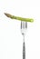 Asparagus spear on fork closeup, on white