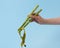 Asparagus spears in a woman`s hand holding yellow measuring tape.
