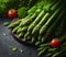 Asparagus stalks in a splash of water on the table.