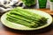 asparagus stems on a green ceramic platter