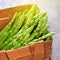 Asparagus stems in the rustic wicker box.