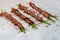 Asparagus wrapped in bacon with spices, grilled on paper for baking