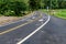 Asphalt bicycle road with yellow line