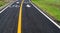 Asphalt bicycle road with yellow line