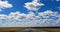 Asphalt blurred road and sunlight and blue sky with clouds.