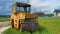 Asphalt compactor roller out of the work, close-up view to the industry machinery on countryside, 4k video footage