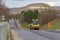 Asphalt compactor roller rolls new asphalt on the highway in the village