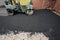 Asphalt Compactors is carrying out road repair work. Laying new asphalt. Large heavy machinery. Construction of a new