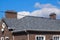 Asphalt . Decorative bitumen shingles on the roof of a brick house