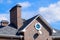 Asphalt . Decorative bitumen shingles on the roof of a brick house