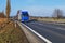 Asphalt highway and blue truck