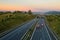 Asphalt highway with ecoduct at sunset