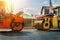 Asphalt higway road construction site. Heavy industrial machinery at roadworks and blue sky backround. Steam roadroller , paver