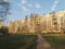 Asphalt path to the panel apartment building. Typical panel construction,