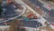 Asphalt paver, roller and truck on the road repair site during asphalting timelapse. Road construction equipment.