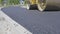 Asphalt paving. Applying fresh layer of asphalt with heavy machinery