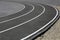 Asphalt racetrack on a stadium, abstract sports background