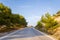 An asphalt road in the arid but green mountains , in Europe, Greece, Crete, towards Tsoutsouros, By the Mediterranean sea, in