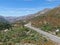 Asphalt road bends through Angeles National forests mountain, California, USA.