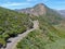 Asphalt road bends through Angeles National forests mountain, California, USA.