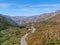 Asphalt road bends through Angeles National forests mountain, California, USA.