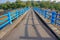 Asphalt road on the bridge with an iron fence on the edge