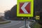 Asphalt road with bright traffic signs in situ of the sharp left turn